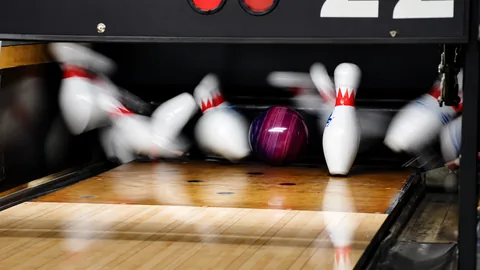 Bowling ball striking the pins
